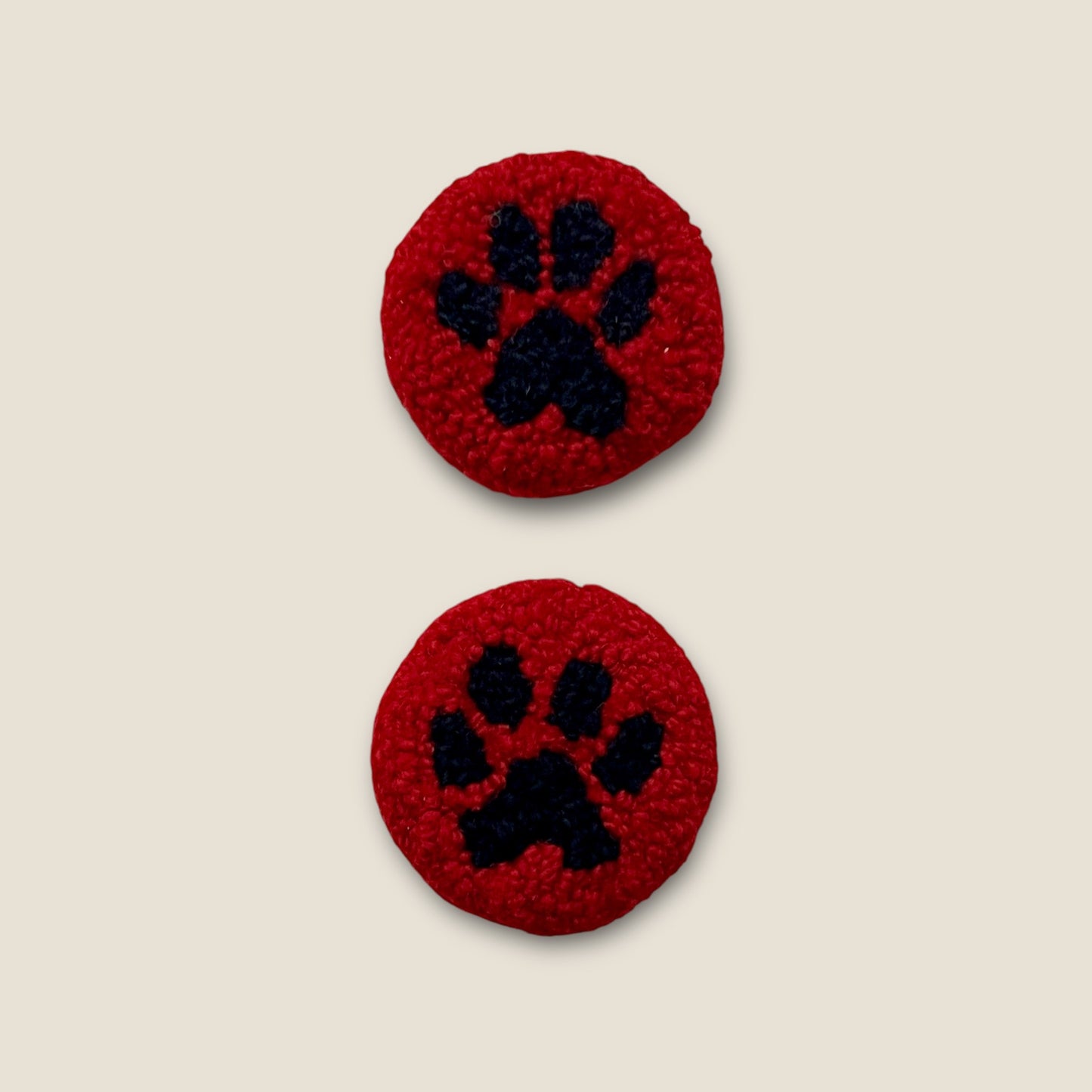 coasters made with black wool for paw and red wool for background