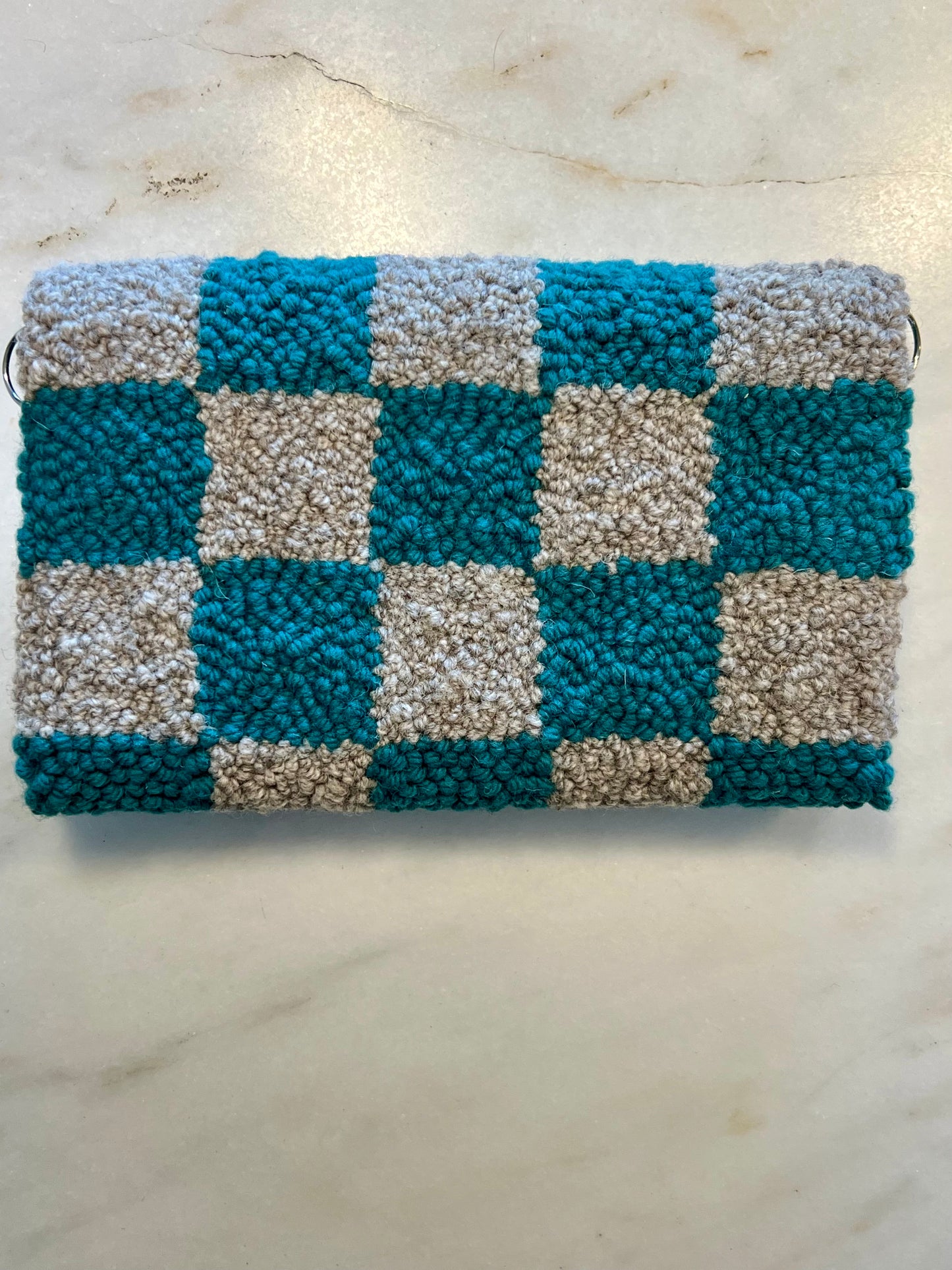 back of purse showing grey and turquoise checkered design