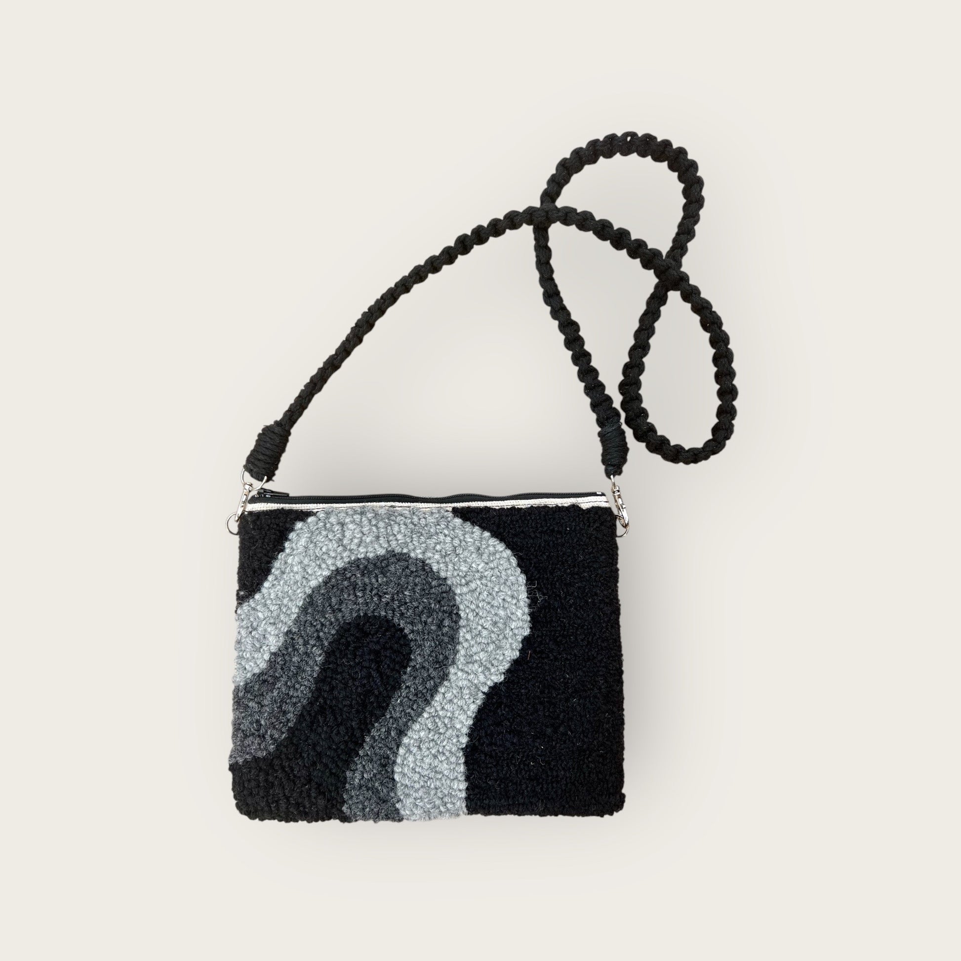 made with black and 2 shades of grey wool yarn