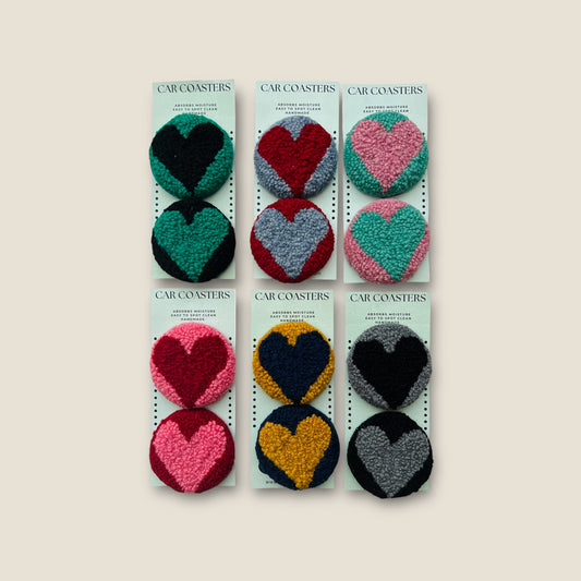 pairs of coasters with hearts on them made using wool yarn to fit in the cup holder of your car