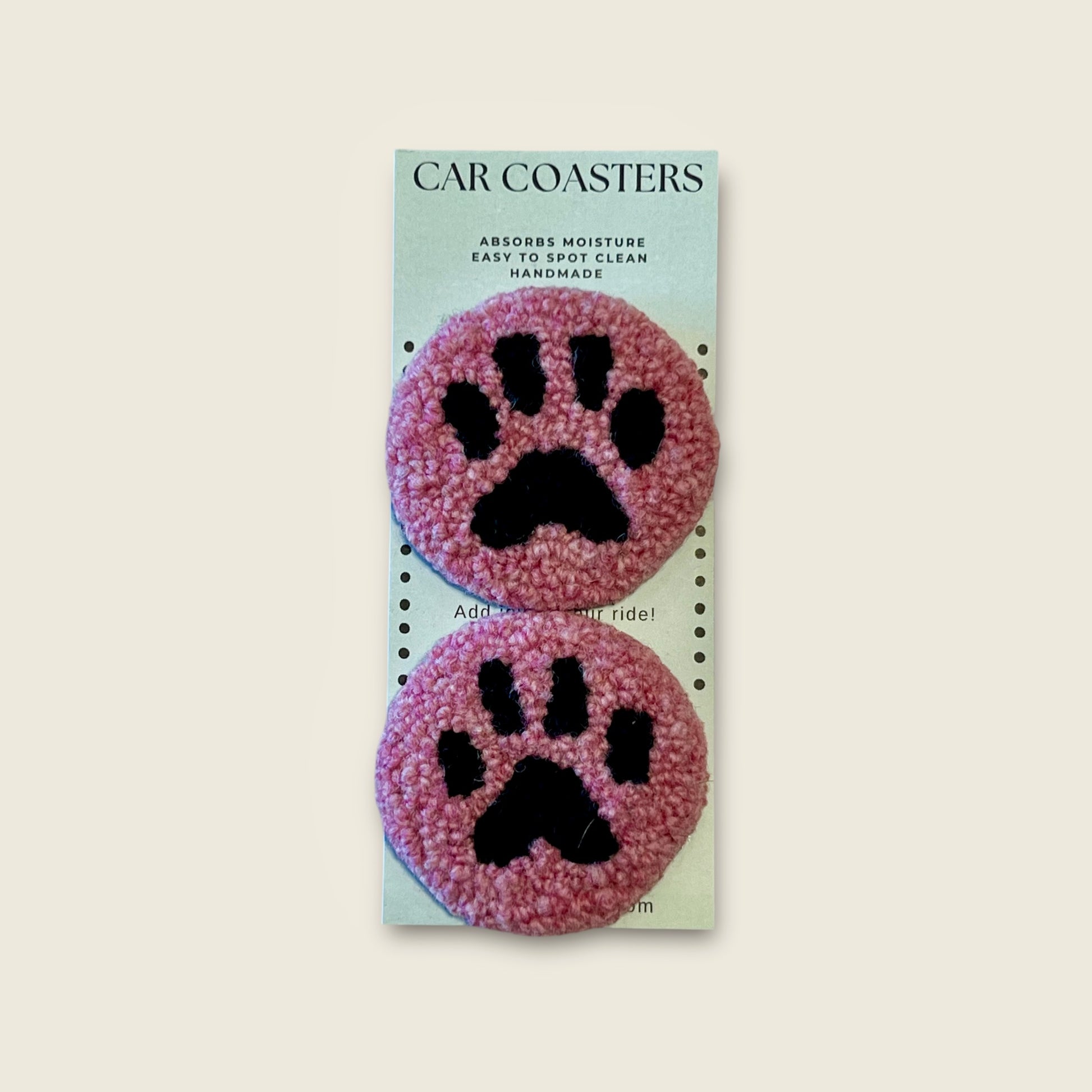 coasters made with black wool  for paw and pink wool for background