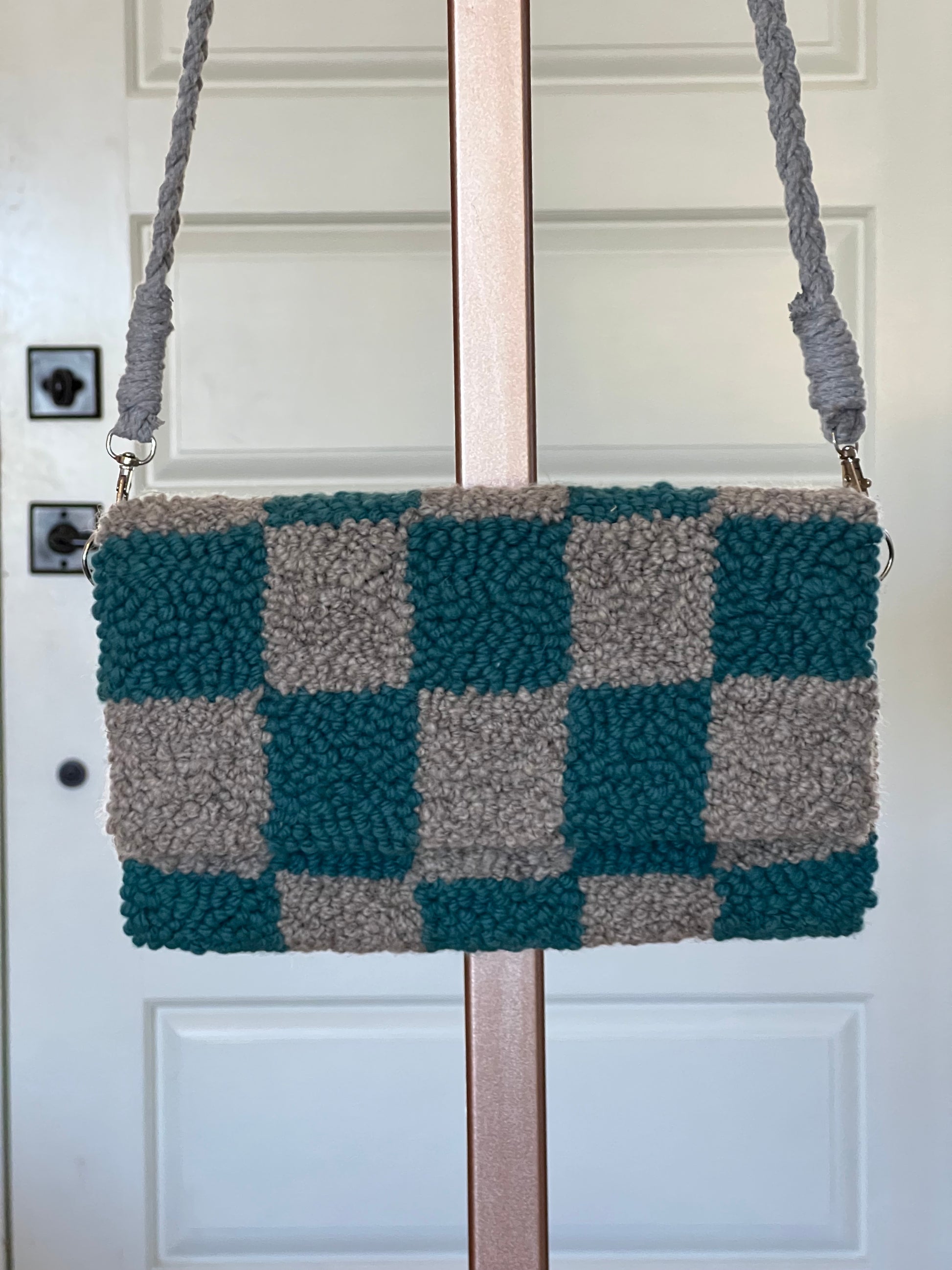 view of clutch hanging with grey strap