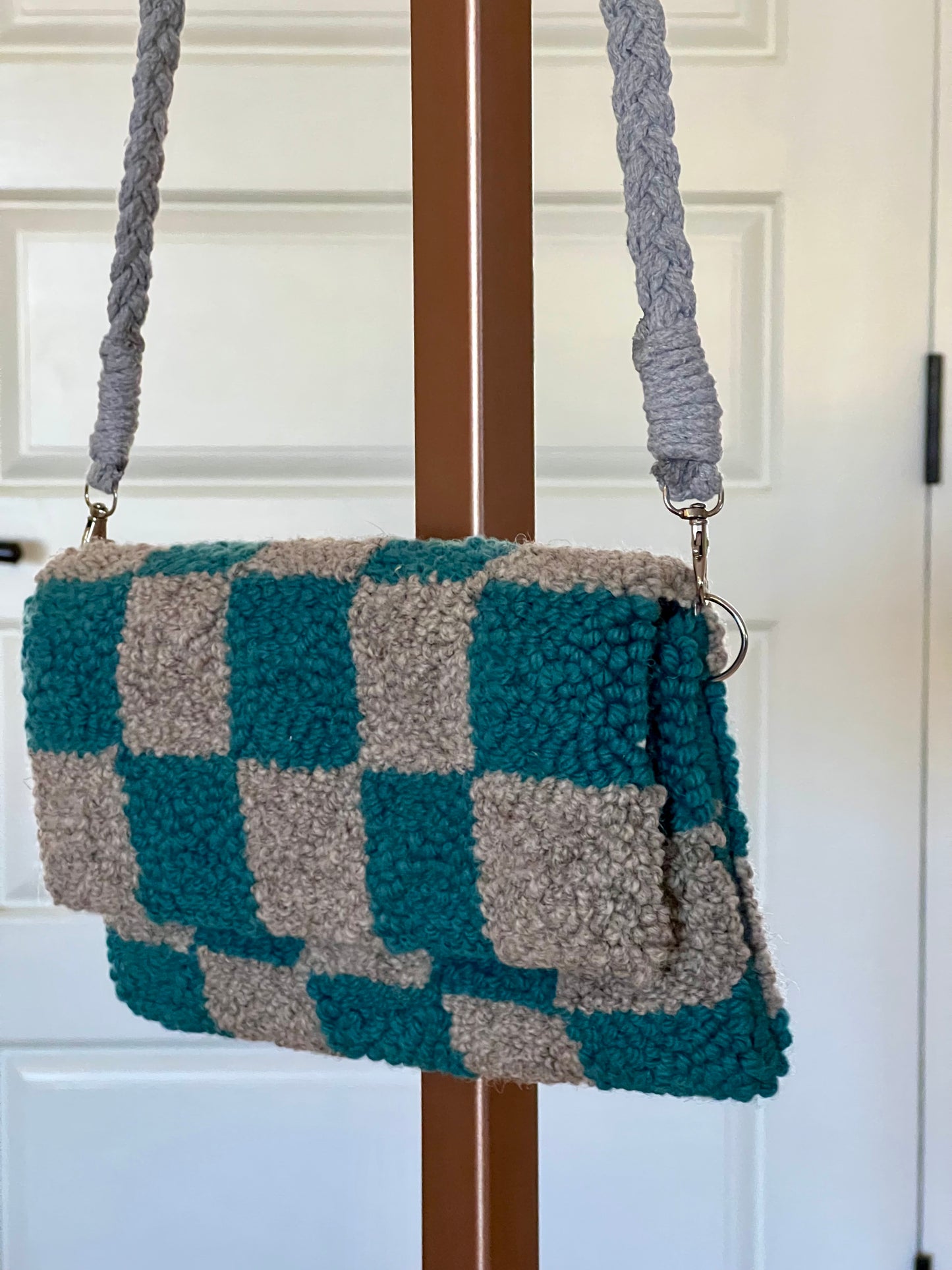 checkered clutch comes with detachable braided grey cross body strap