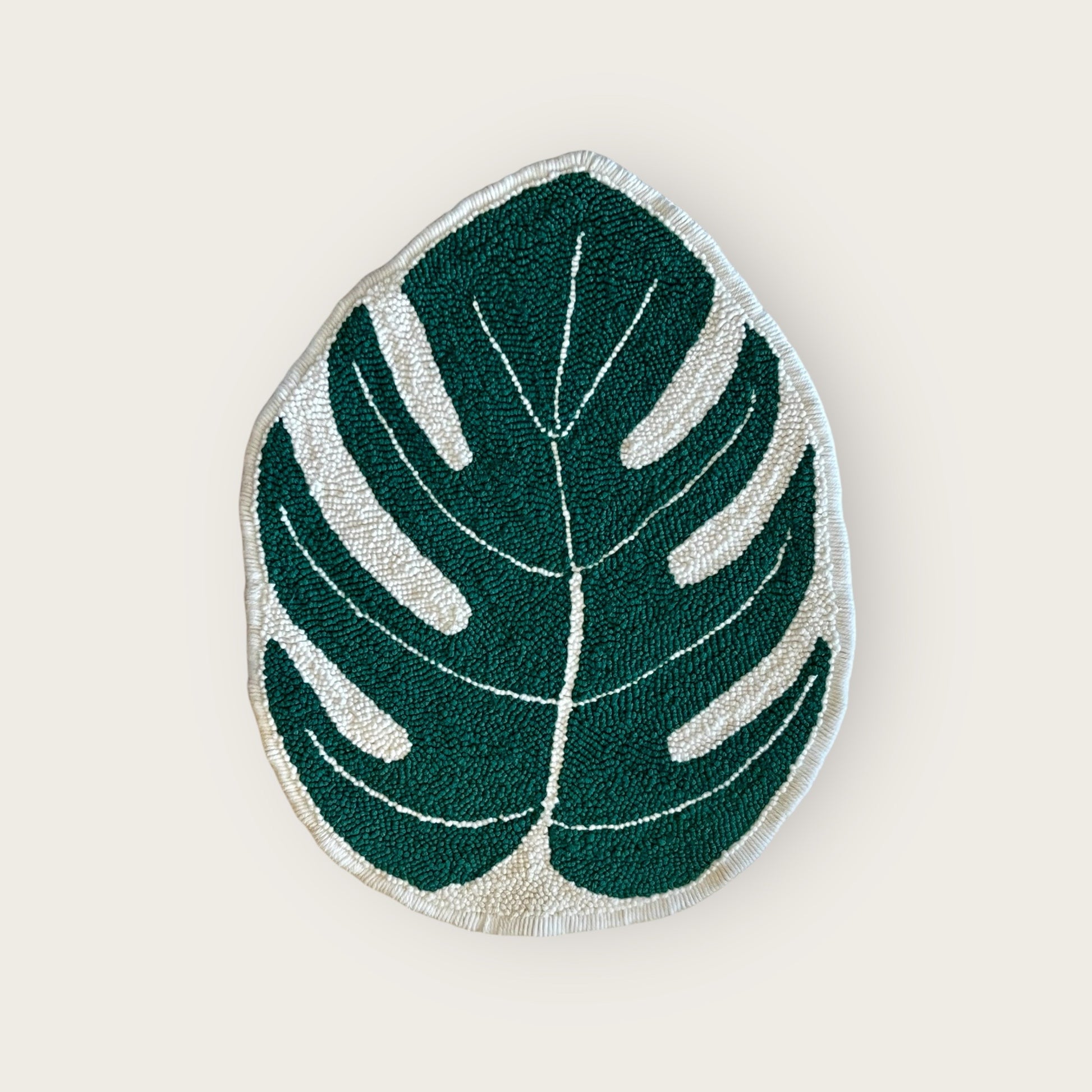 Hand made punch needle Monstera rug showing loop side