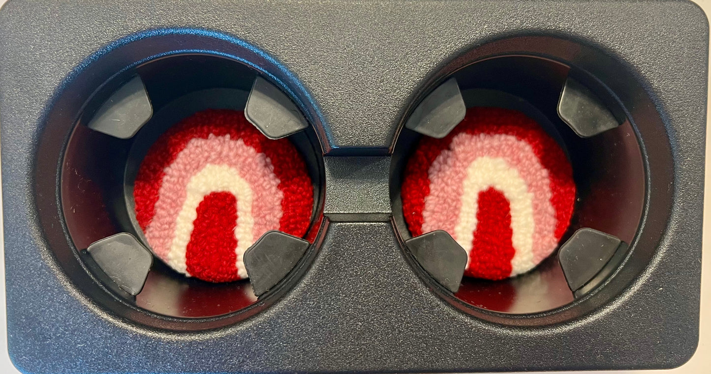 View of coasters in the cup holder of a car
