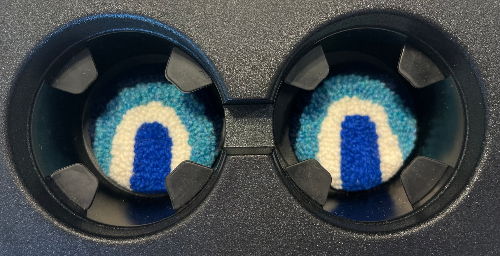 View of coasters in the cup holder of a car
