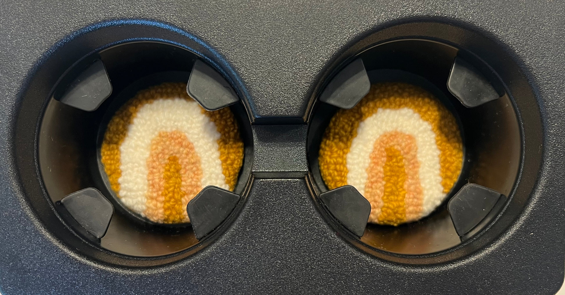 View of coasters in the cup holder of a car
