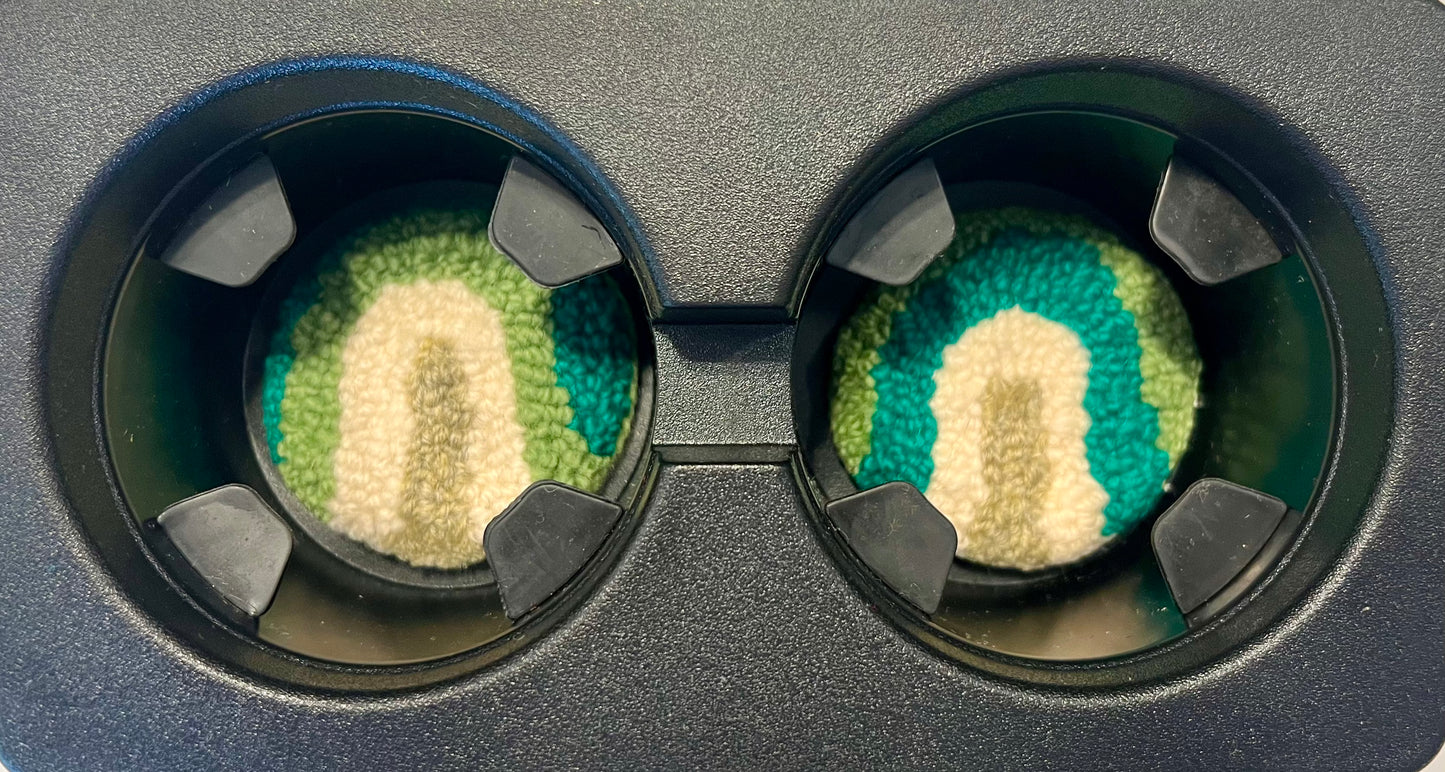 View of coasters in the cup holder of a car
