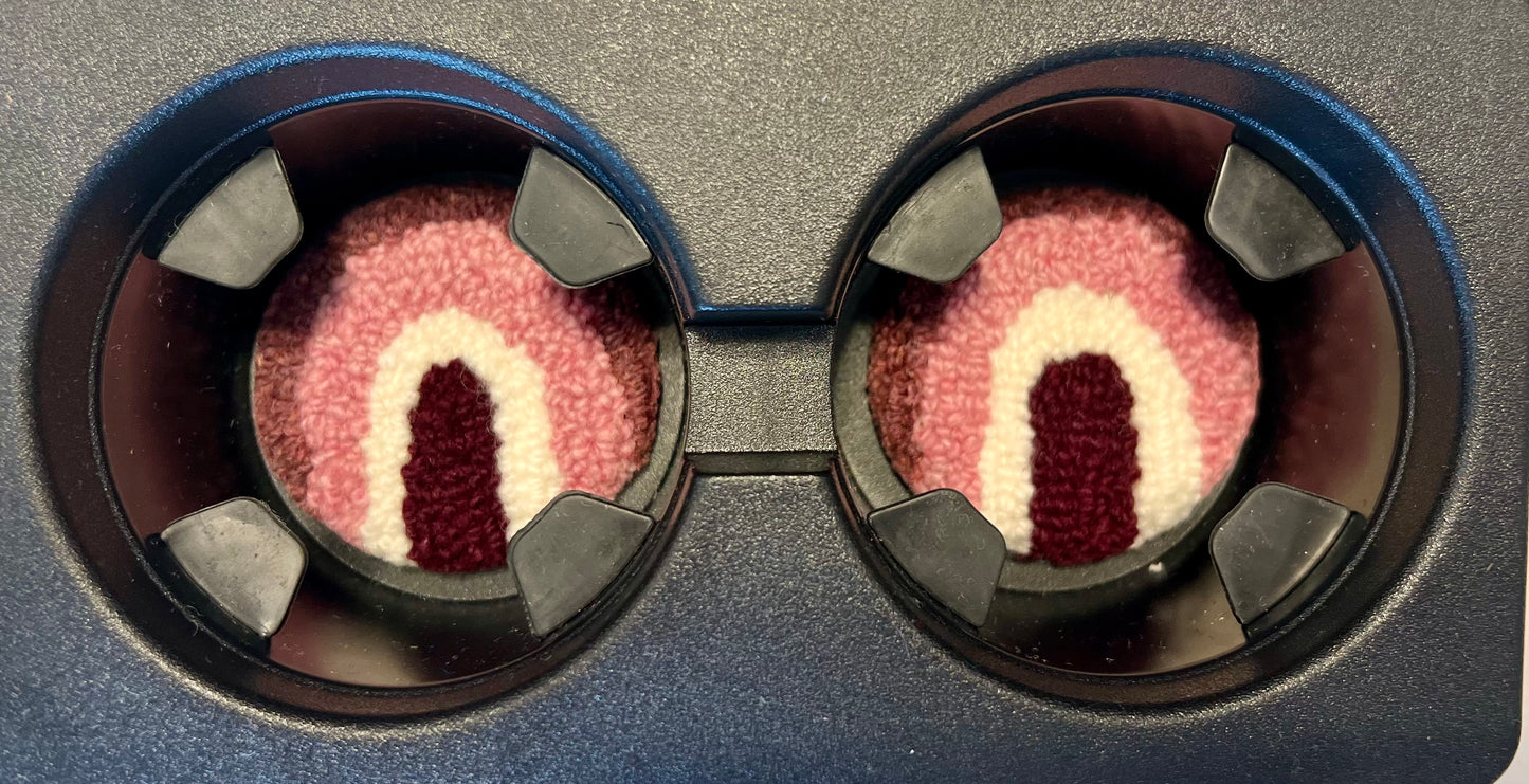 View of coasters in the cup holder of a car

