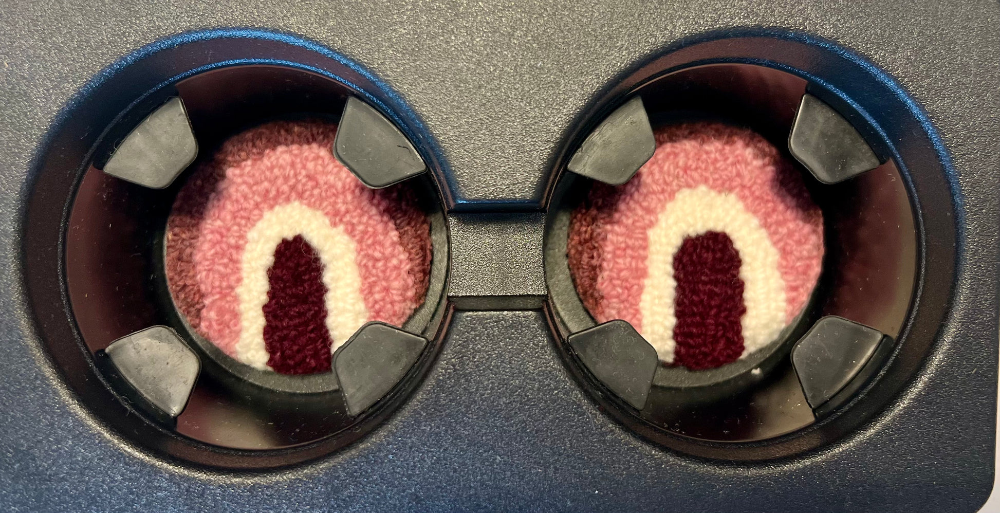 View of coasters in the cup holder of a car
