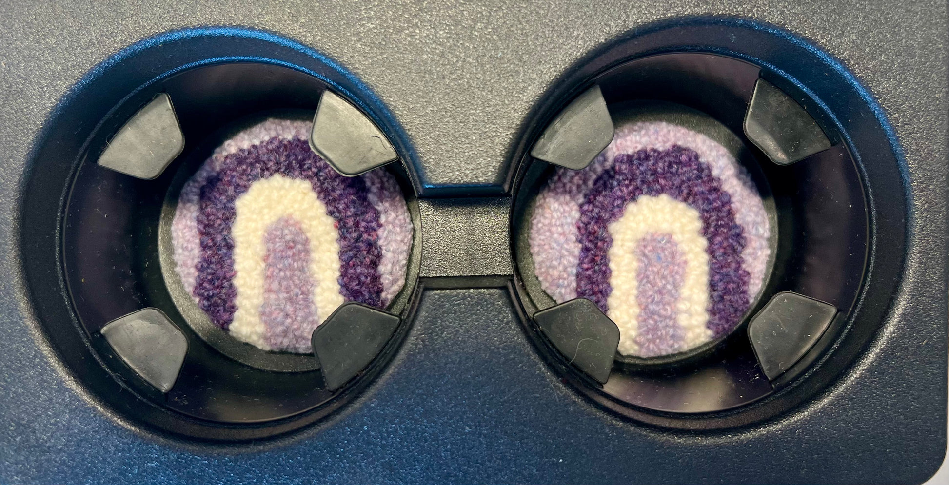 View of coasters in the cup holder of a car
