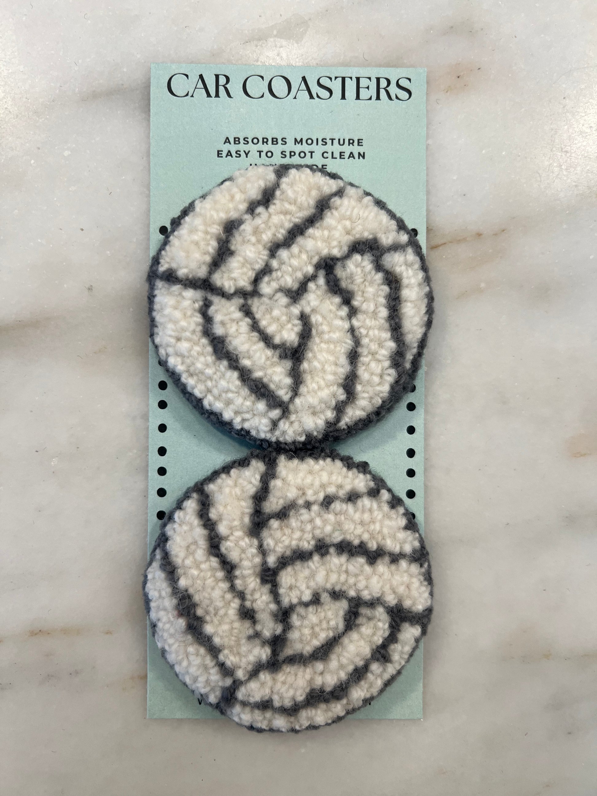 pair made of wool to put in the cup holder of your car for absorbing moisture of drink